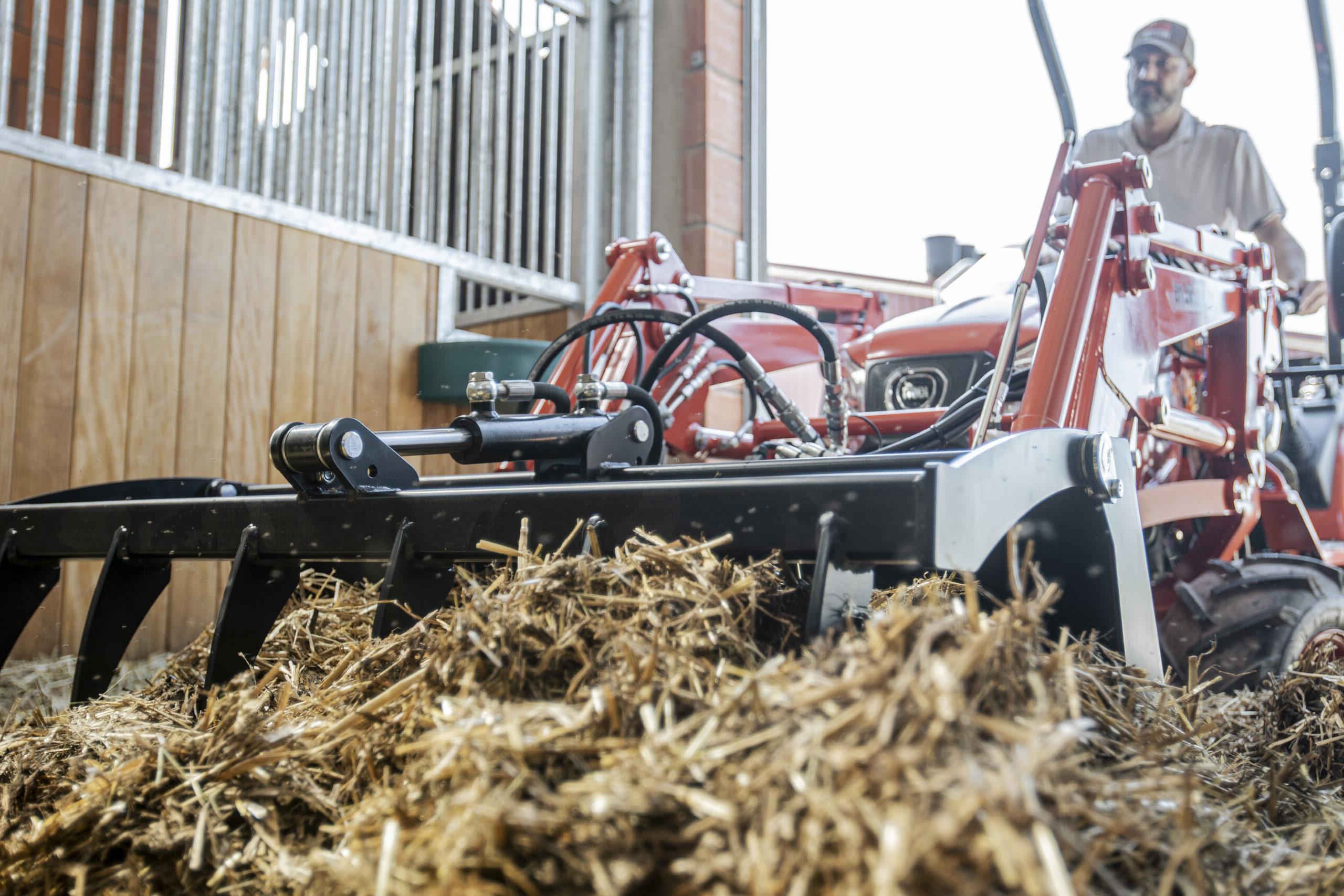 A Kioti tractor for horse farm maintenance with hay